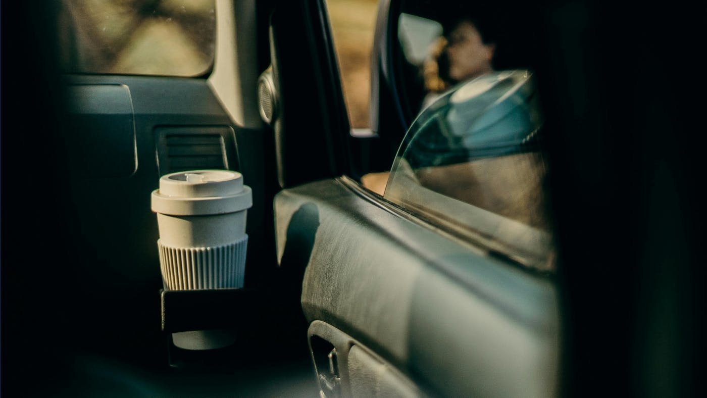 Image of reusable coffee cup in a car cupholder
