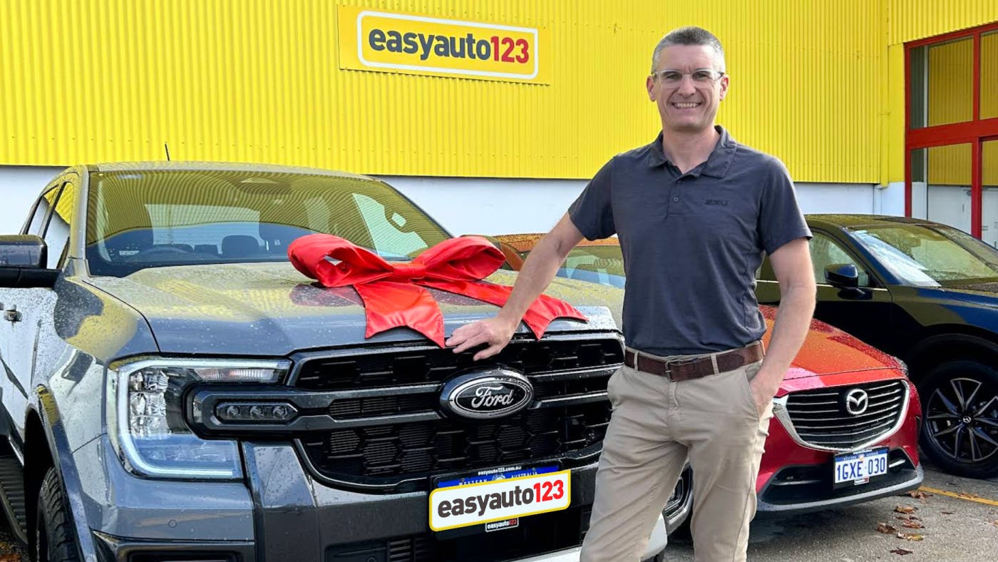 Happy male used car customer with Ford Ranger at easyauto123 used car superstore
