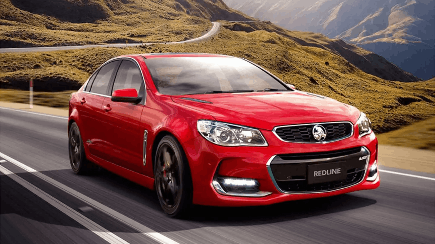 Image of red Holden Commodore SS V8 sportscar driving on twisty mouthain road