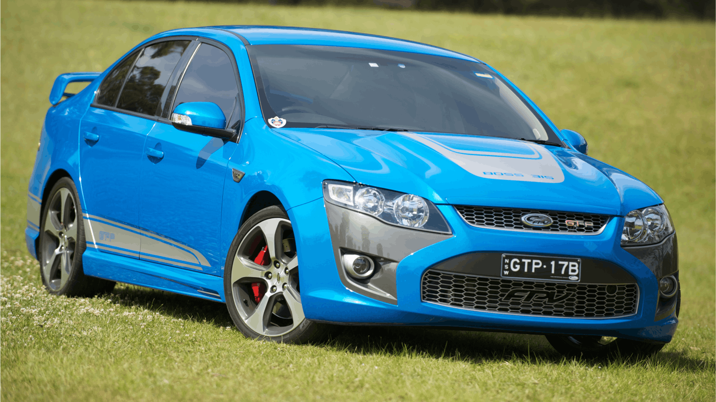 Image of bright blue Ford Falcon GT Boss V8 sportscar parked in field