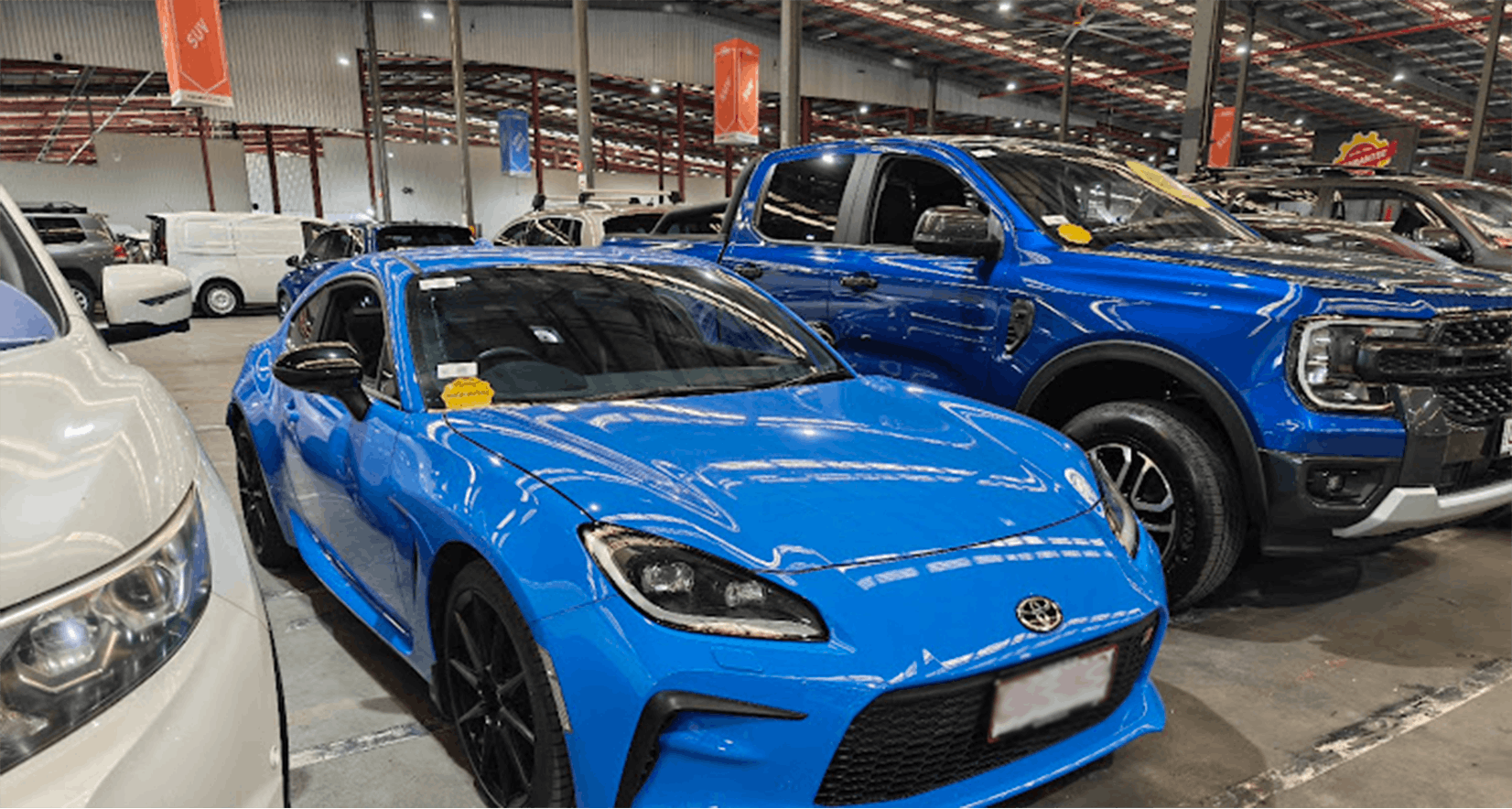 Bright blue Toyota GR86 sports car in an easyauto123 used car warehouse