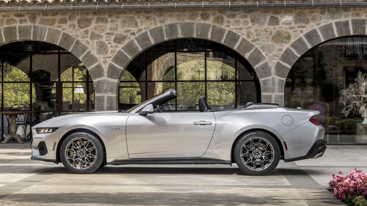 Silver convertible Ford Mustang in courtyard