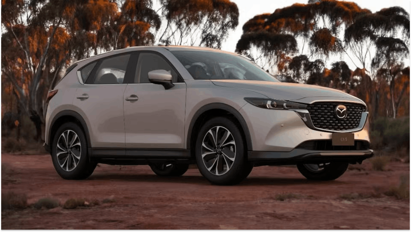 Silver Mazda CX-5 parked on red dirt in Australian bush setting