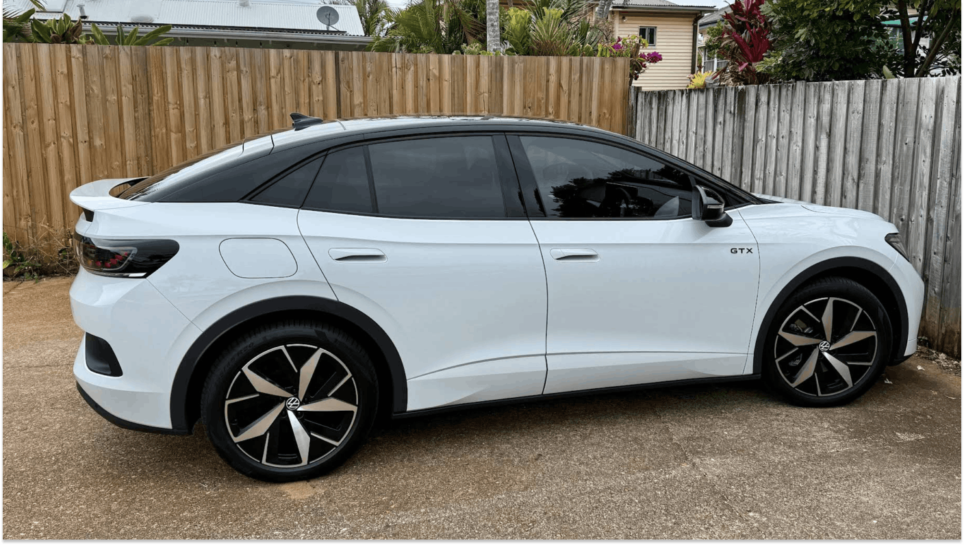 Image of white Volkswagen EV parked in private car park