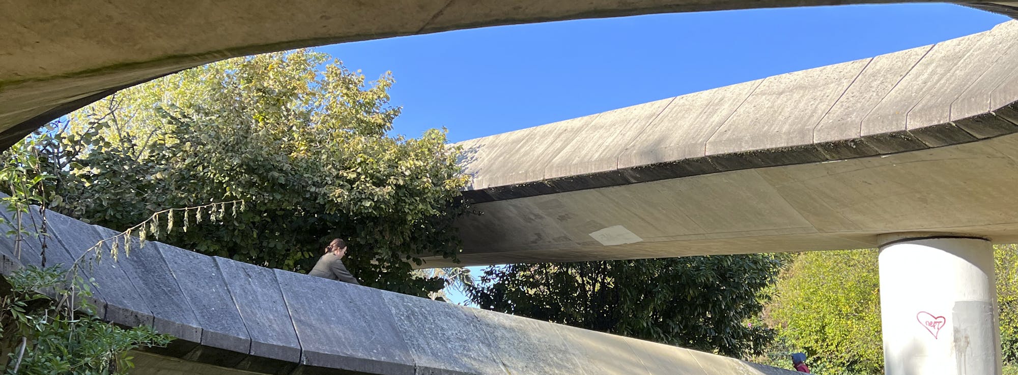 A woman is riding on a bicycle down the circular ramp