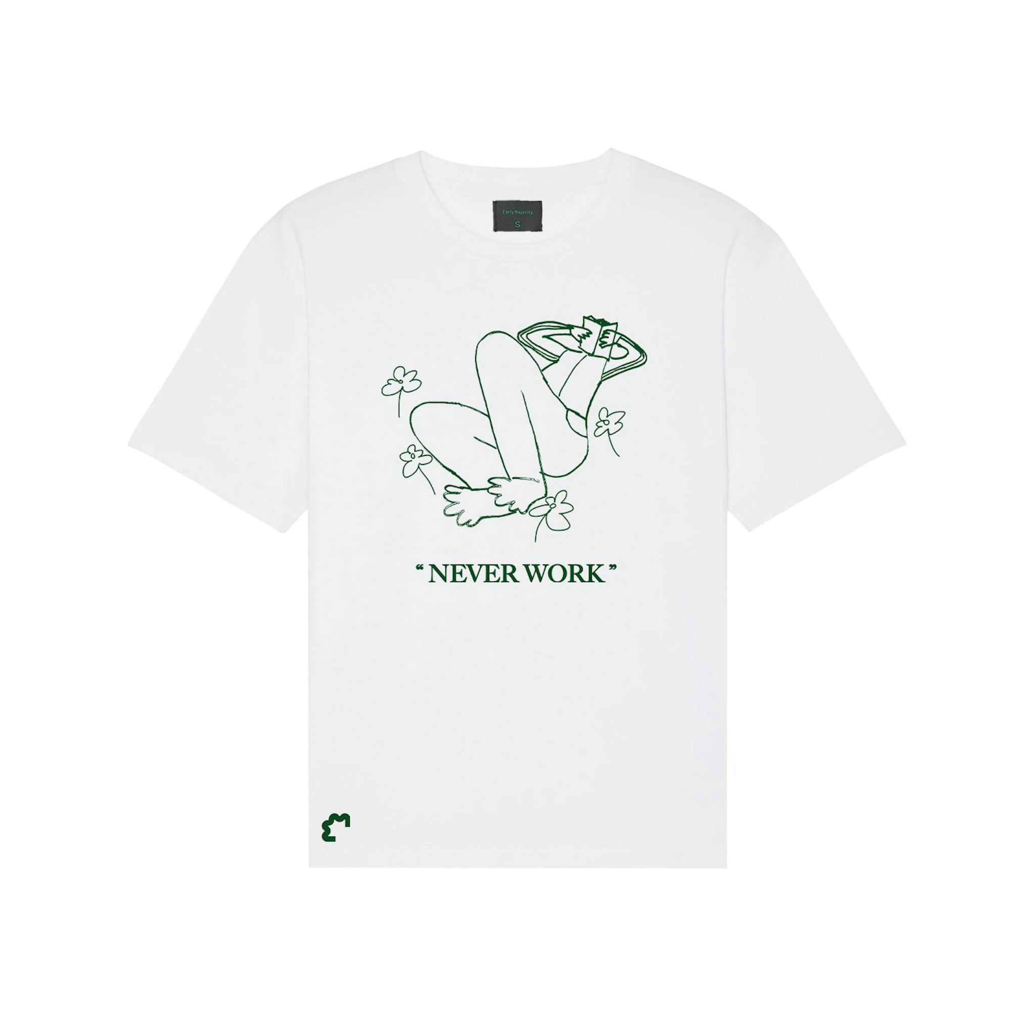 A white T-shirt with a green outline drawing of a figure lying back with legs up, surrounded by flowers, and the phrase "NEVER WORK" below it.