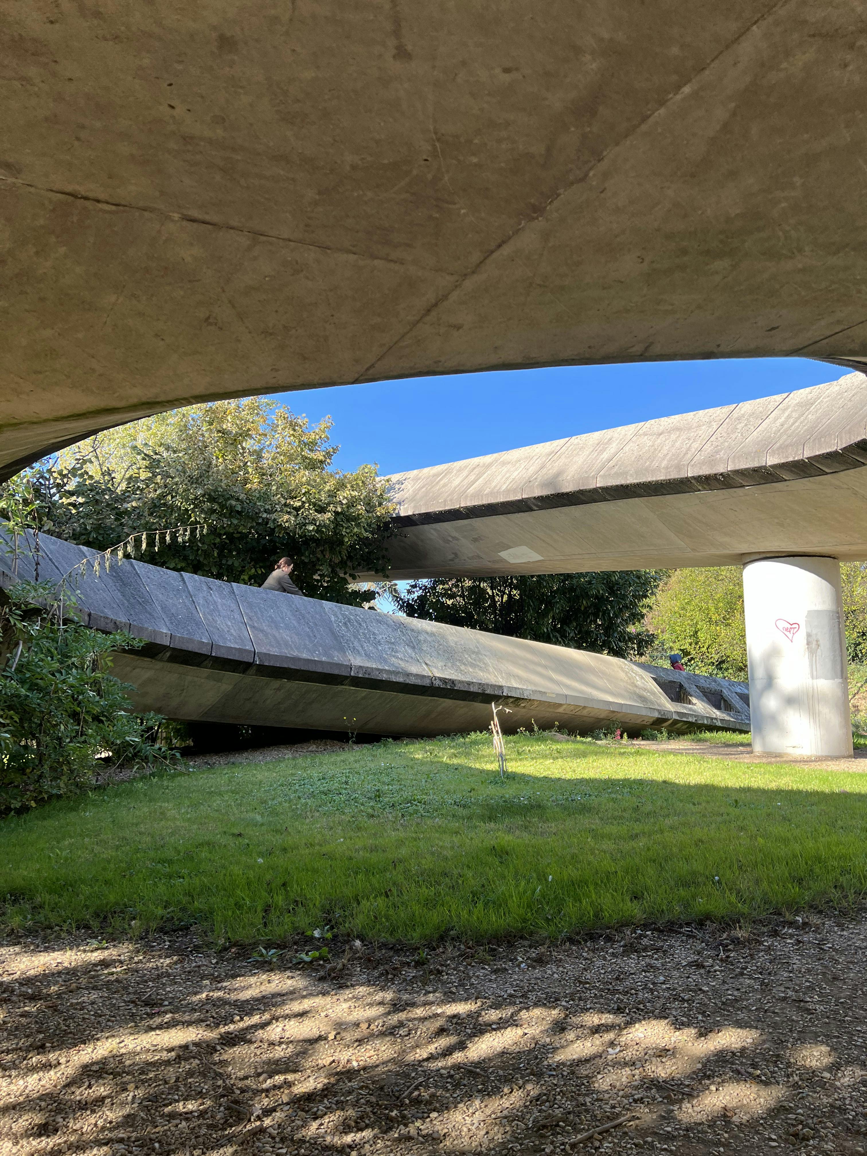 A woman is riding on a bicycle down the circular ramp