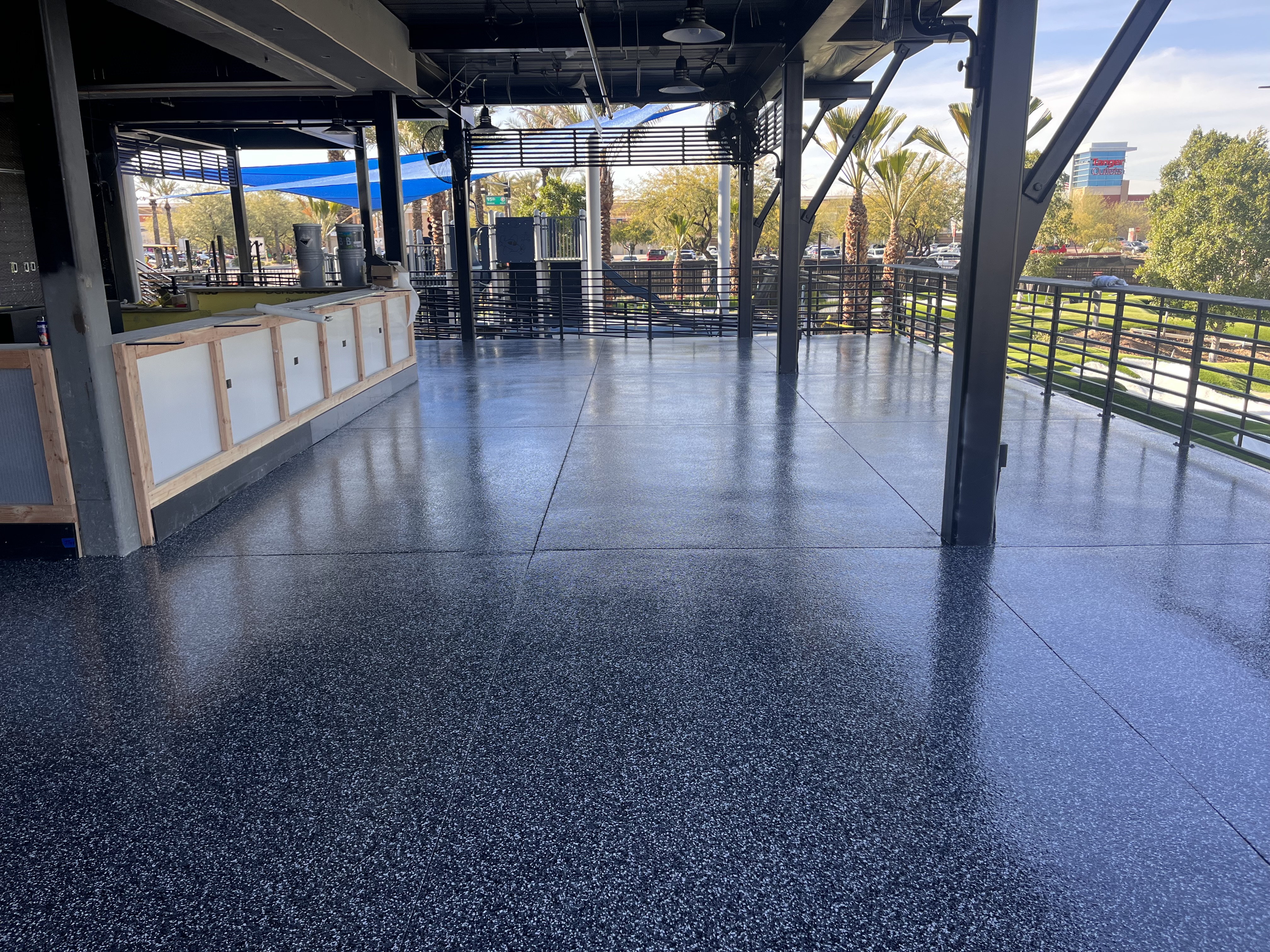 Commercial outdoor patio dining area with flake epoxy floor coating
