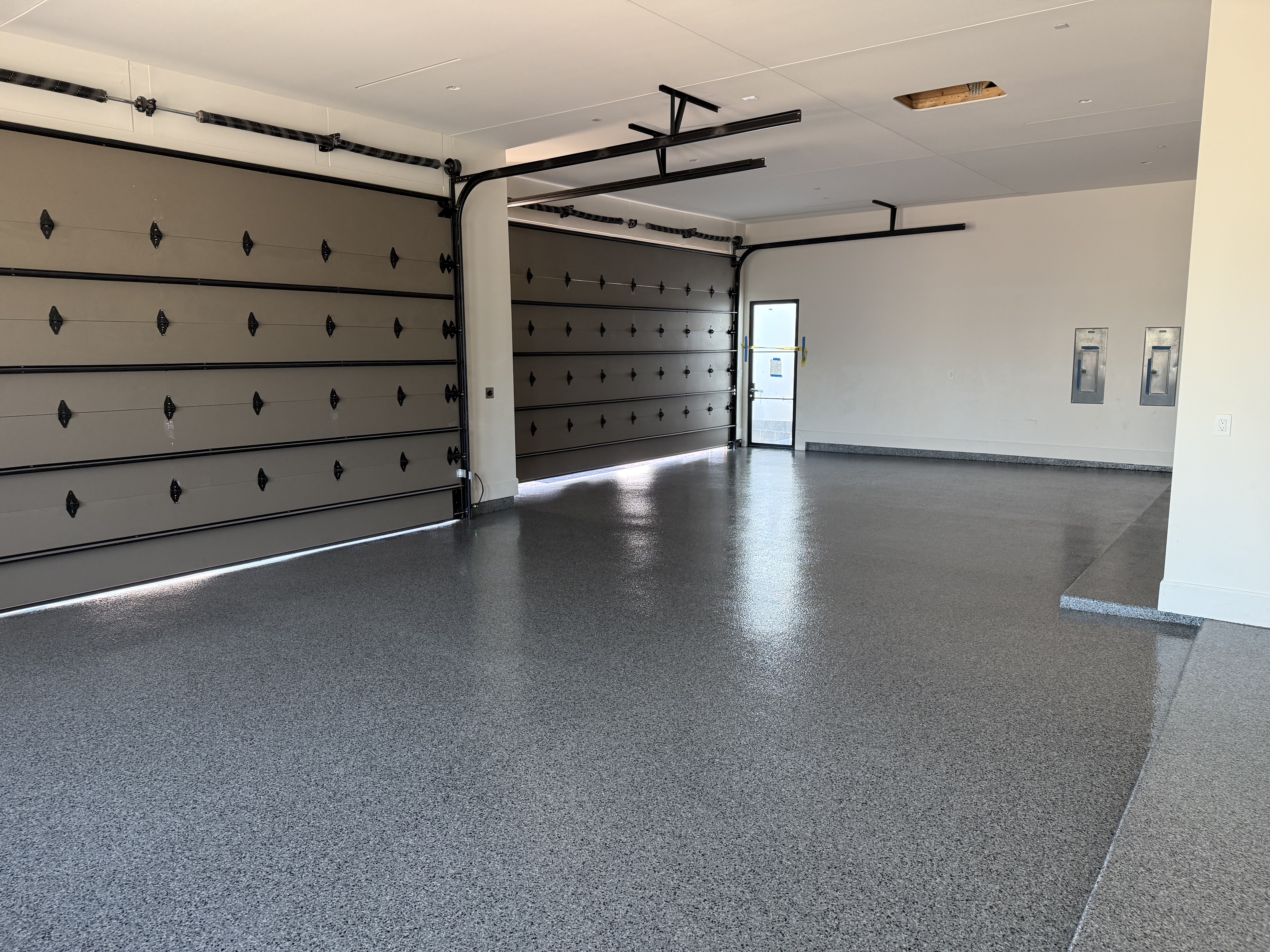 Residential garage with flake epoxy floor coating decorative garage doors and side entry