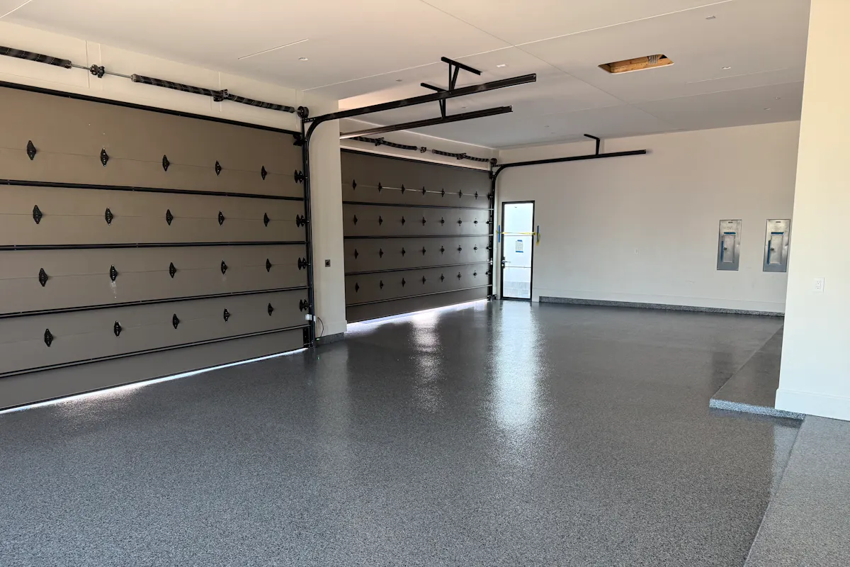 Residential garage with flake epoxy floor coating decorative garage doors and side entry