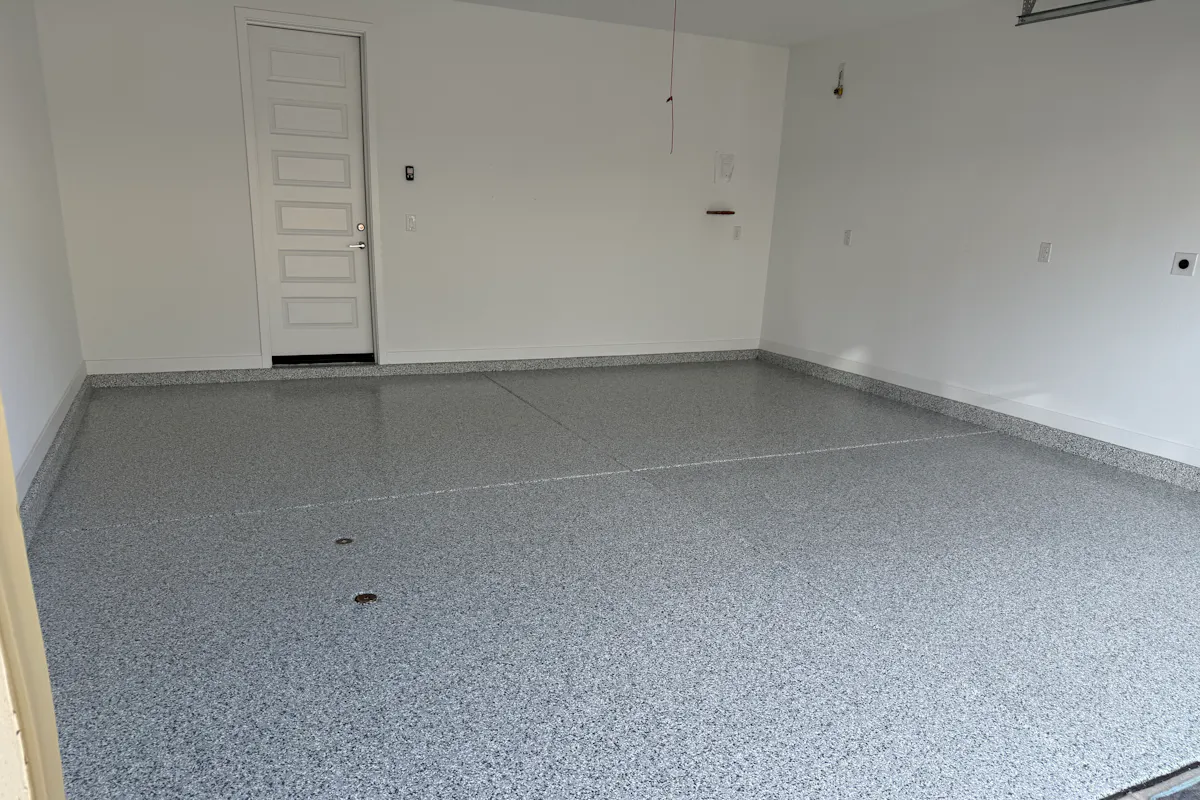 Residential garage with flake epoxy floor coating clean white door
