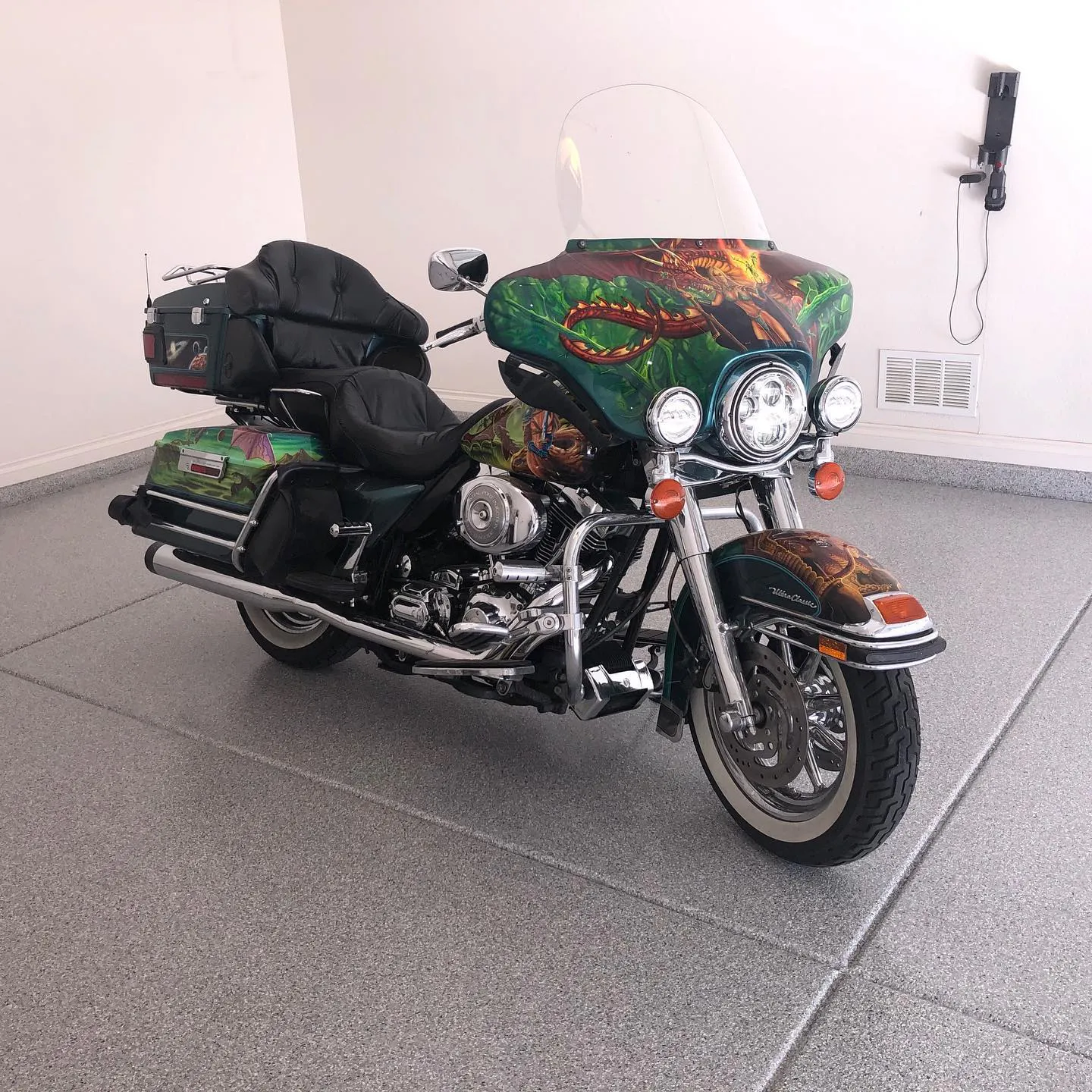 Residential garage with solid polyaspartic floor coating and custom painted Harley motorcycle