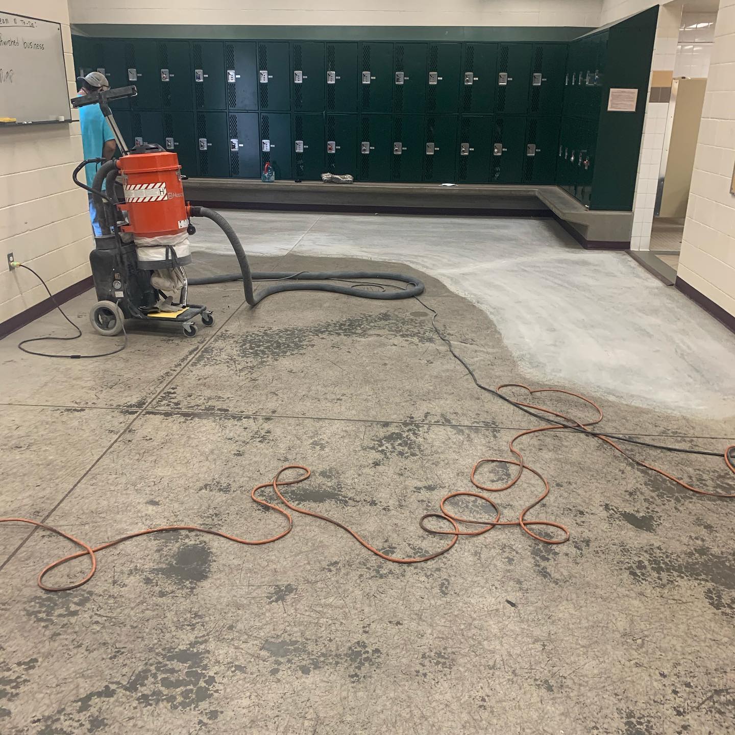 Commercial locker room floor grinding preparation with industrial grinder