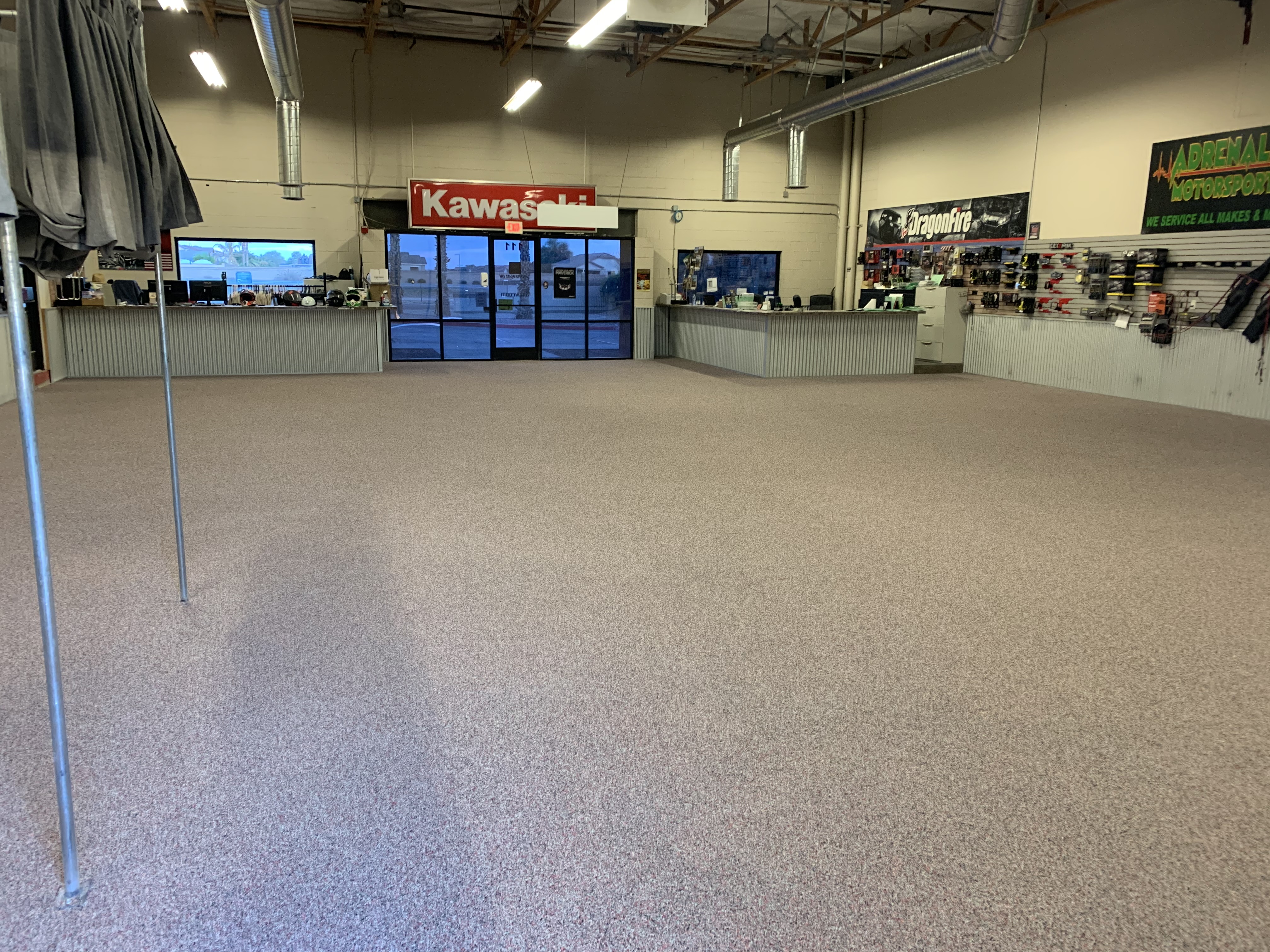 Kawasaki motorsports dealership showroom with flake epoxy floor coating