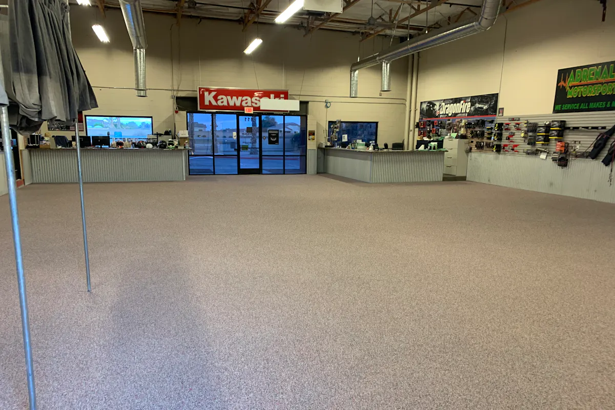 Kawasaki motorsports dealership showroom with flake epoxy floor coating