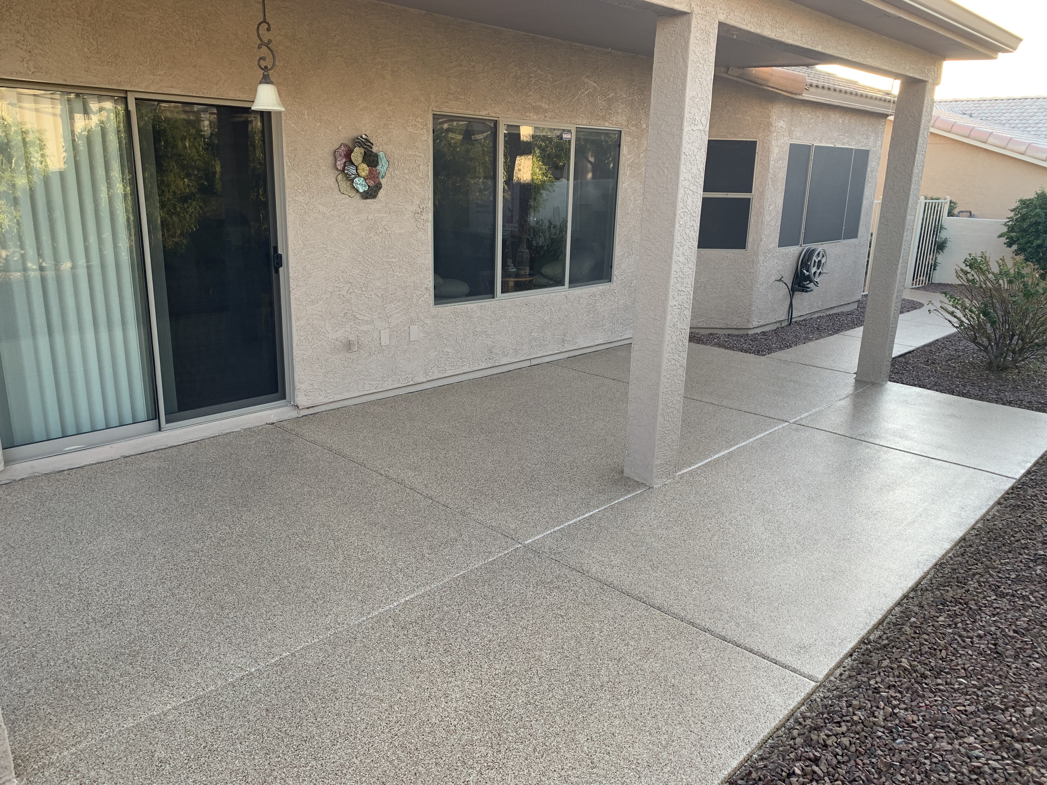 Residential covered patio before coating bare concrete panels Arizona home exterior