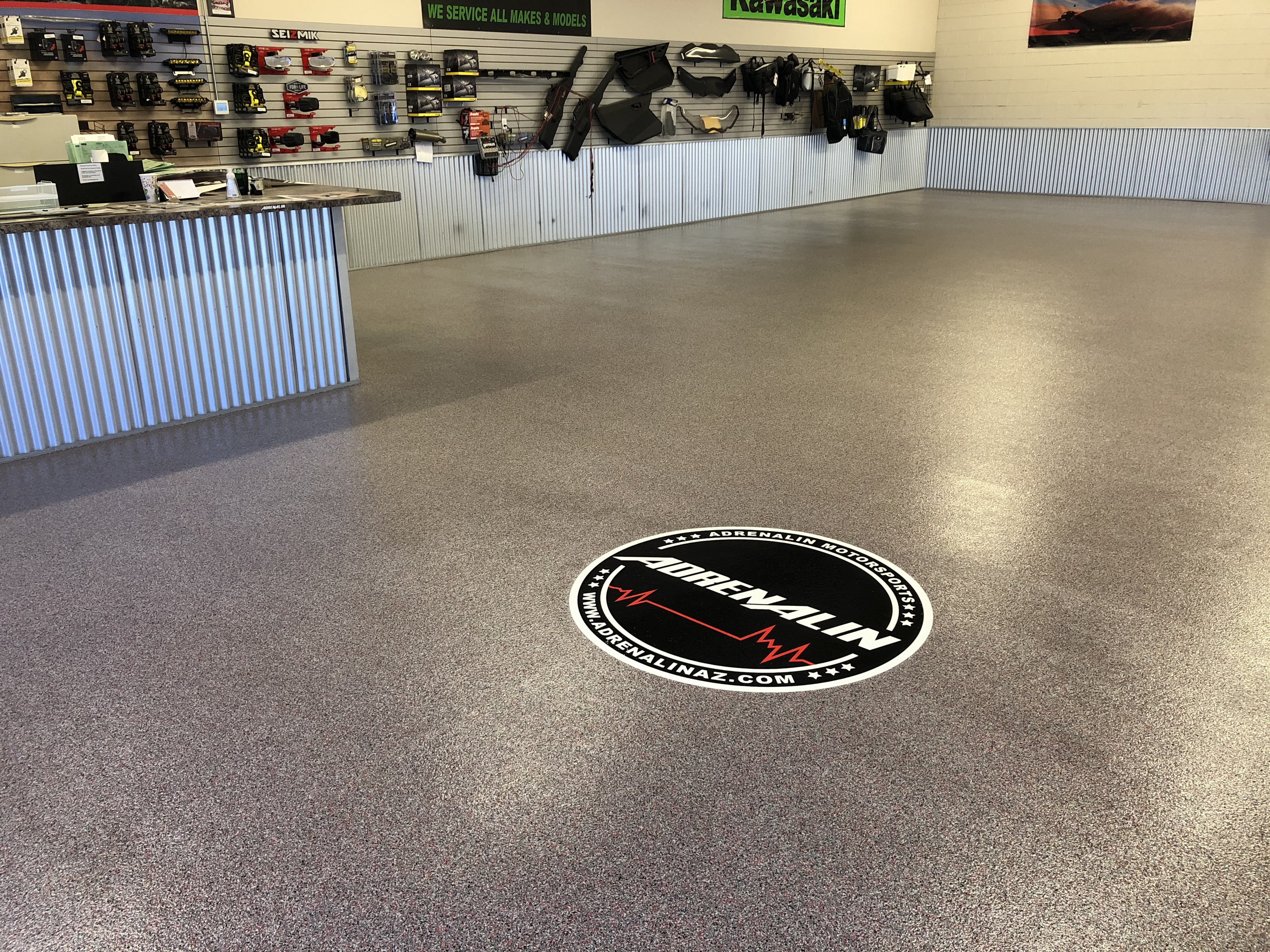 Commercial Adrenalin auto shop showroom with flake epoxy floor coating custom logo decal