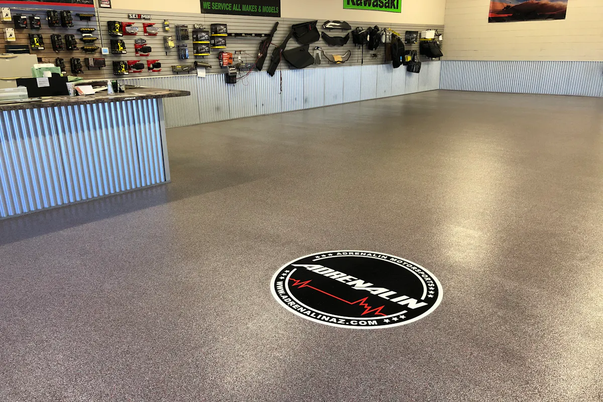 Commercial Adrenalin auto shop showroom with flake epoxy floor coating custom logo decal