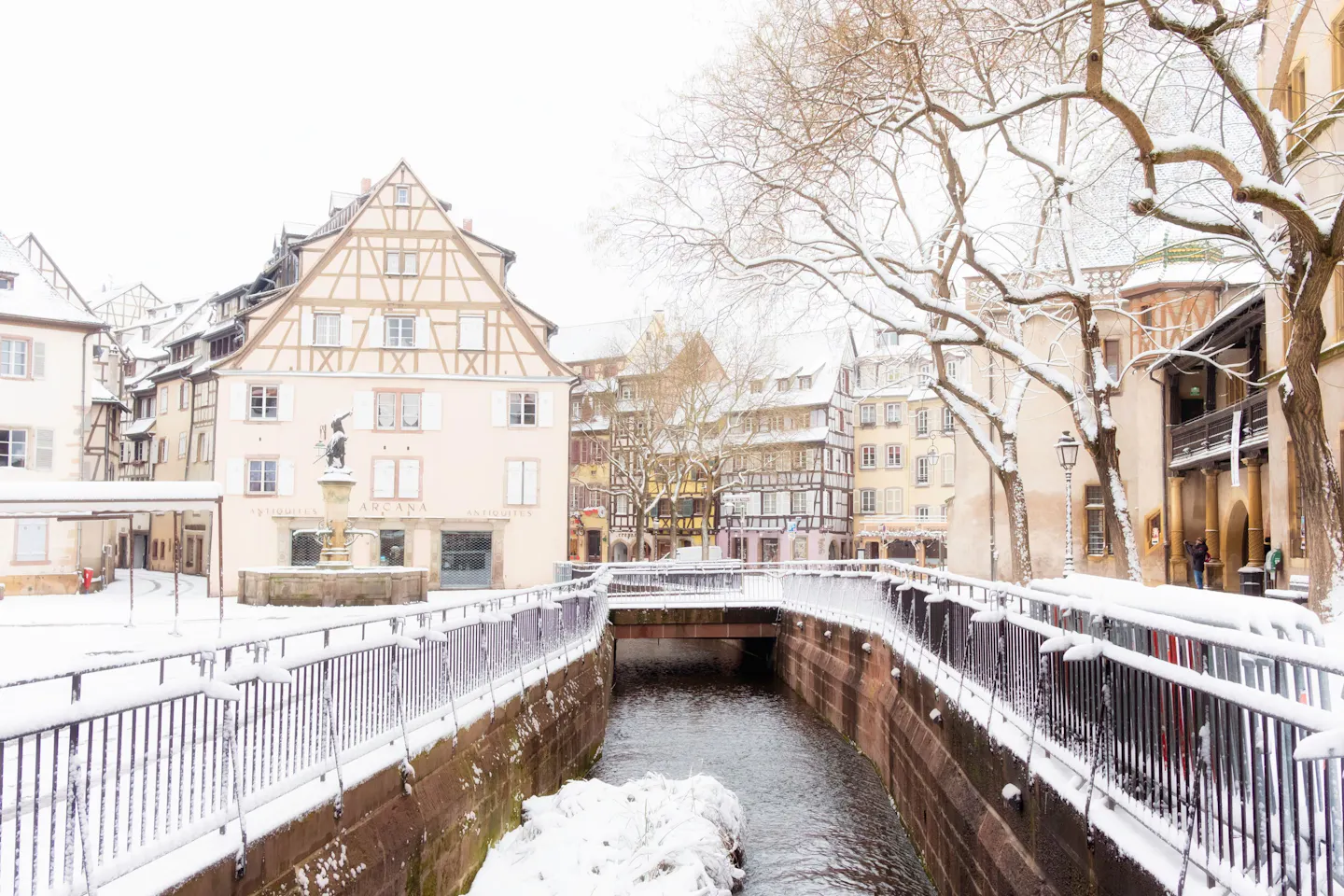 Snow on the half-timbered houses and canal railings in the old centre of Colmar