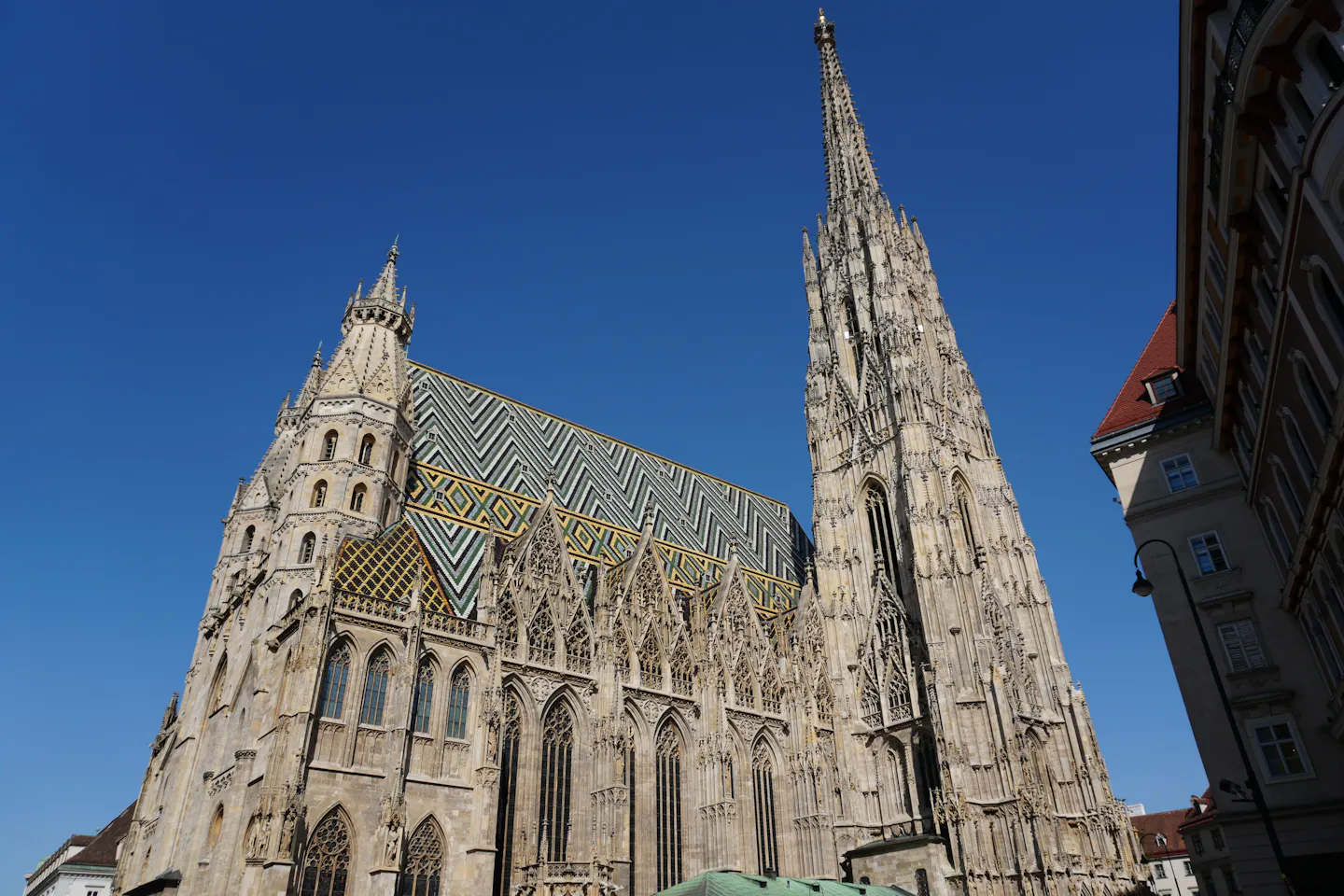 The patterned tiled roof and Gothic spire of St Stephen's Cathedral in Vienna