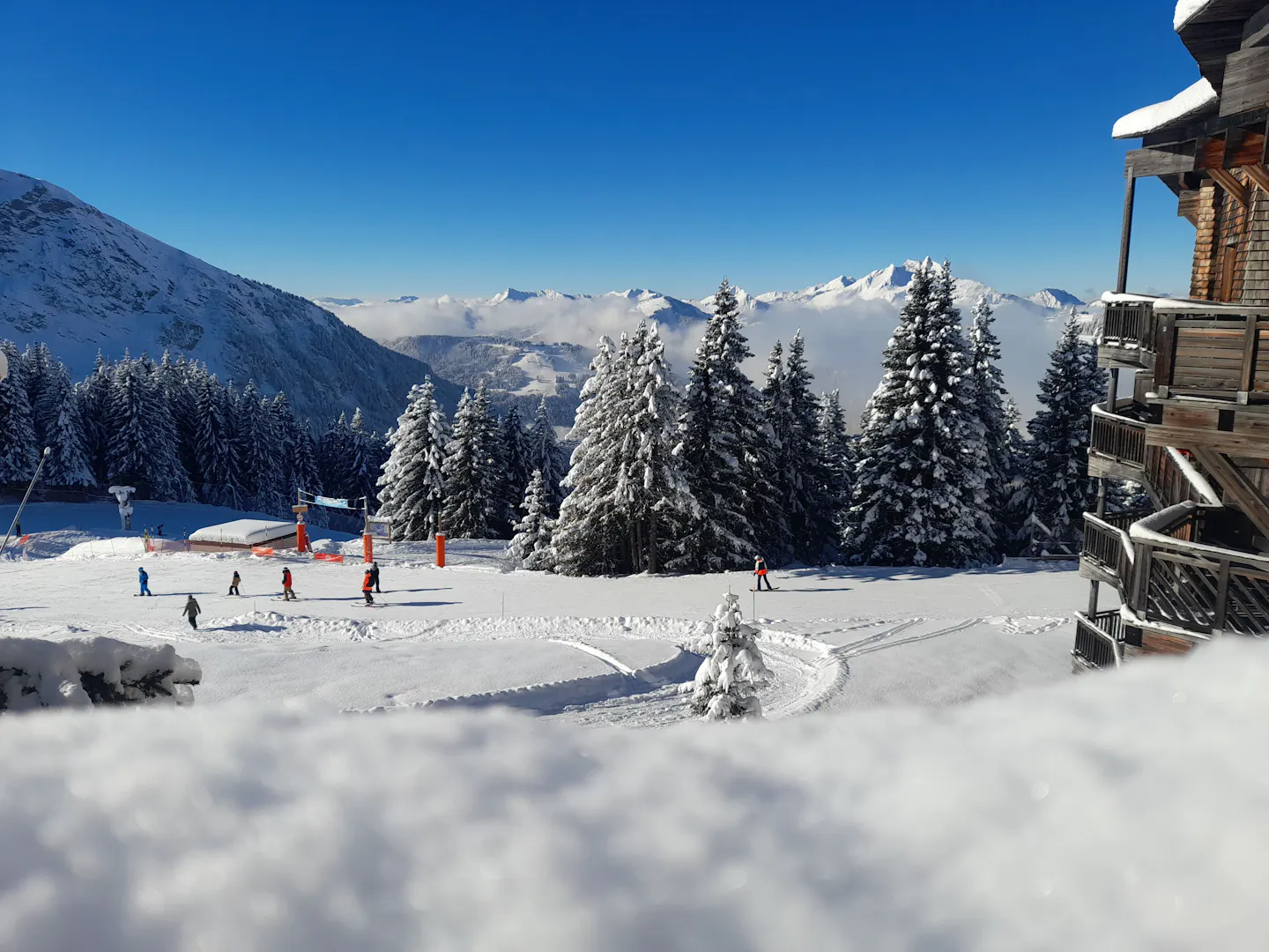 Courchevel ski slopes and snowy Alpine peaks beneath the Courchevel emblem