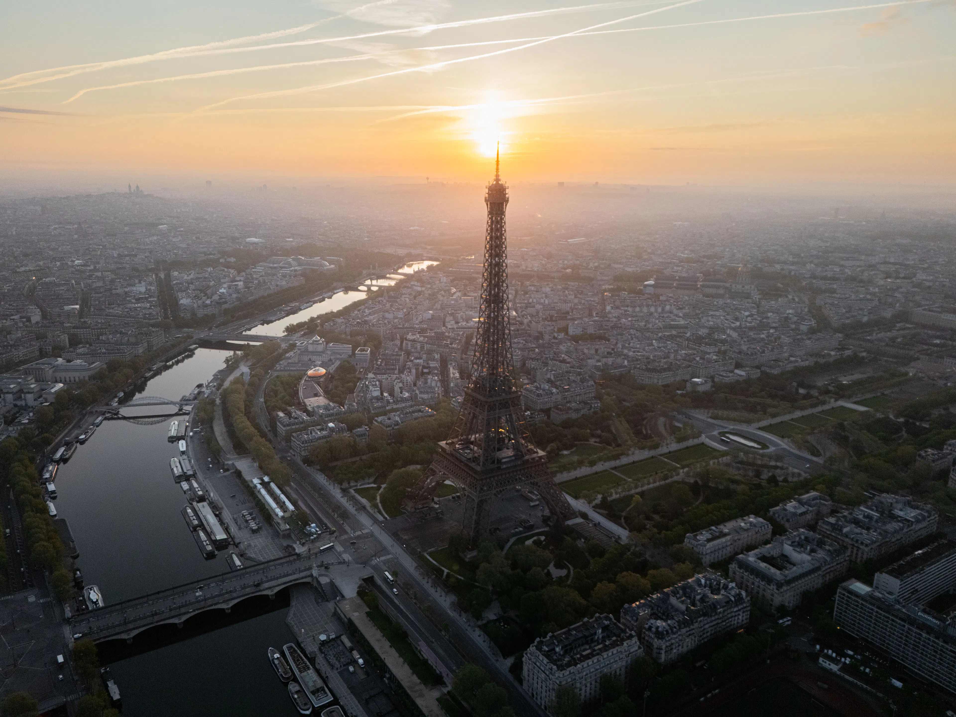 Aerial view of Paris at sunrise with the Eiffel Tower above the Seine and the Champ de Mars