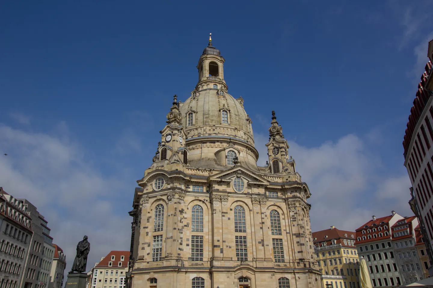 The domed sandstone Frauenkirche rising over the Neumarkt in Dresden under a blue sky