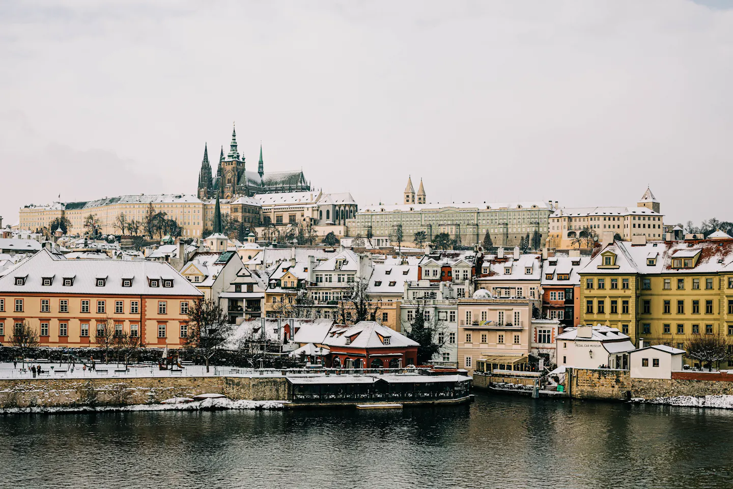 Snow-covered rooftops of Prague's Mala Strana below the castle and St Vitus Cathedral