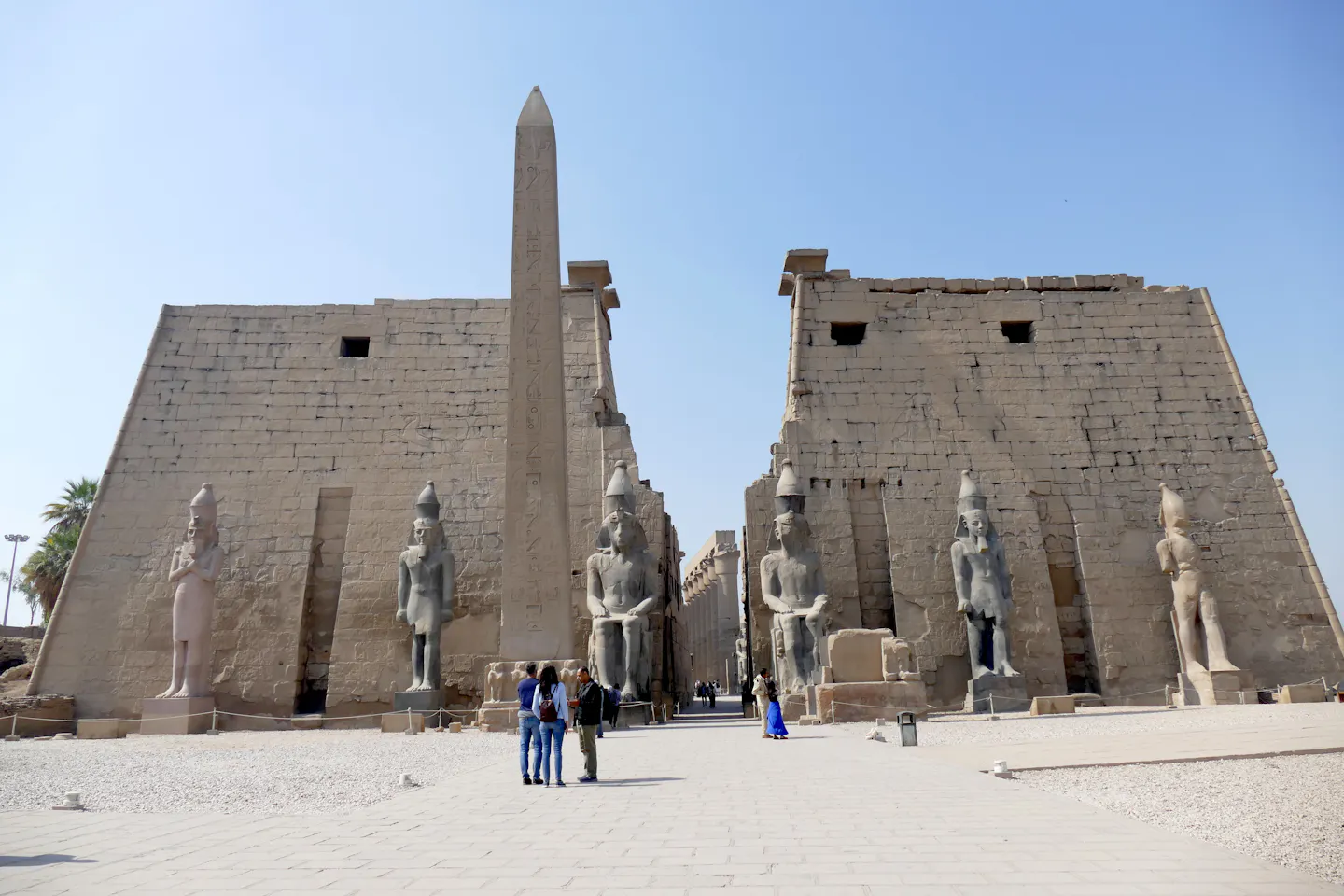 The pylon, obelisk and seated colossi at the entrance to Luxor Temple in Egypt