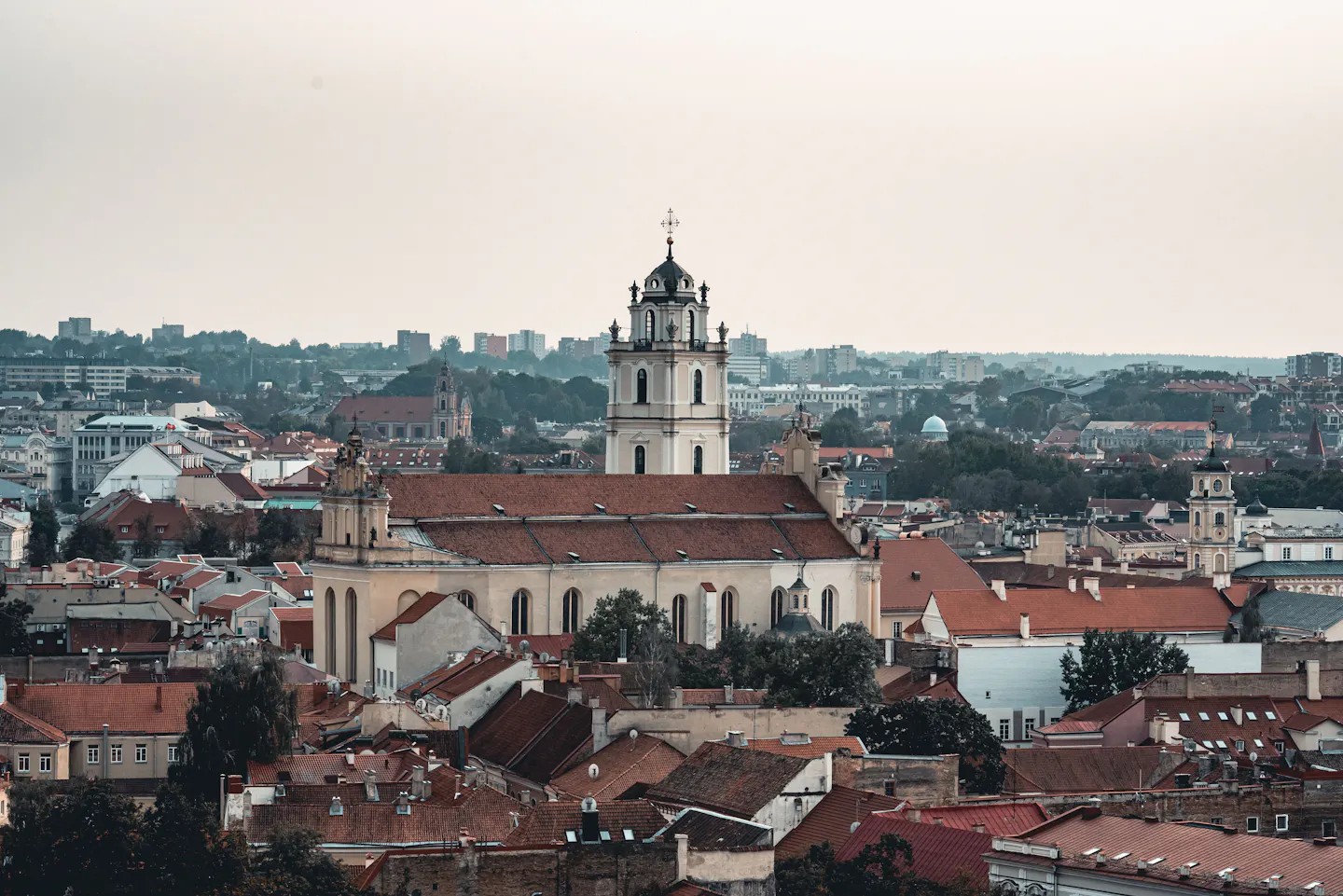 The white bell tower of Vilnius University above red-tiled Old Town roofs