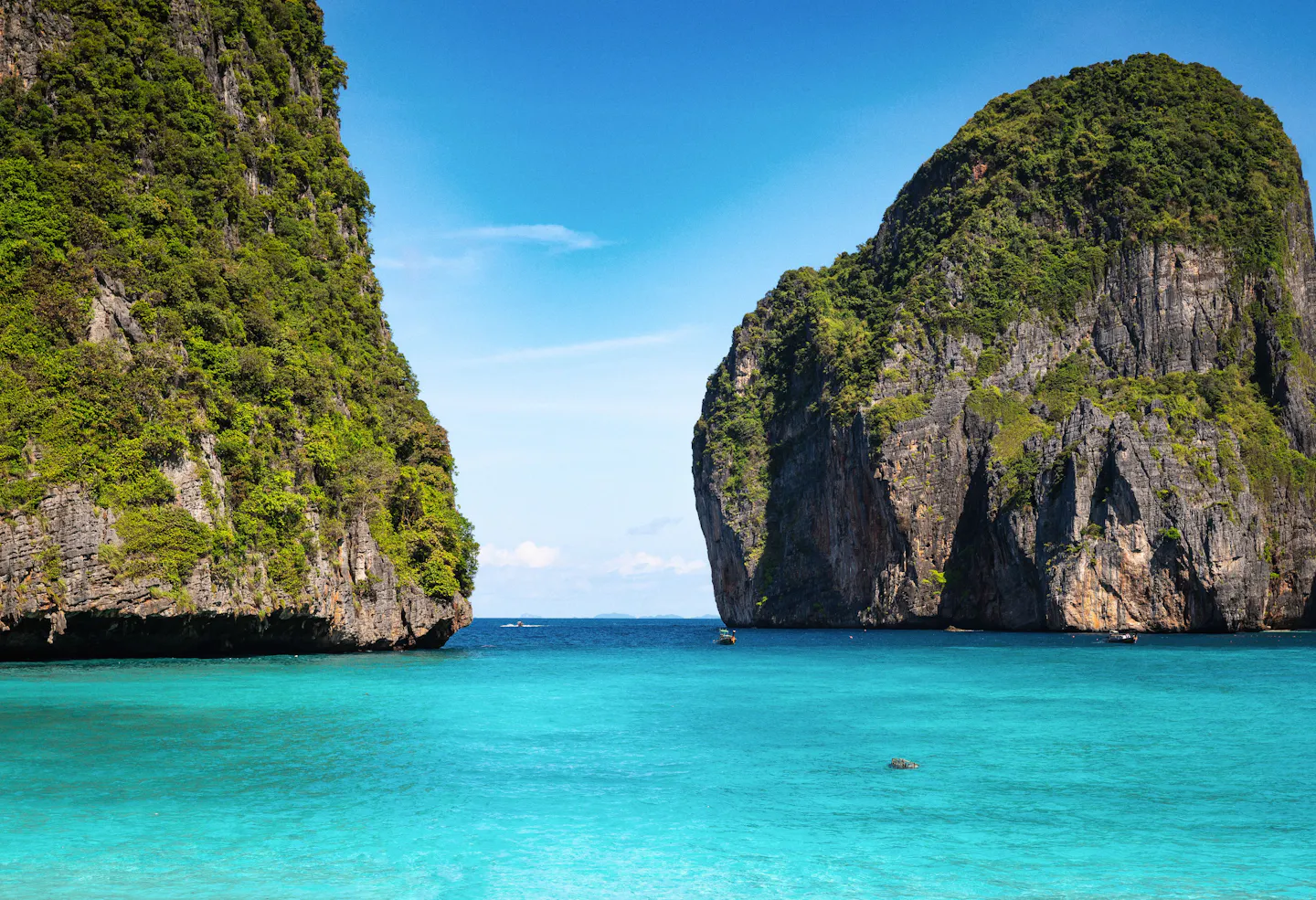This photo shows the emerald waters and dramatic limestone cliffs of Southern Thailand.
