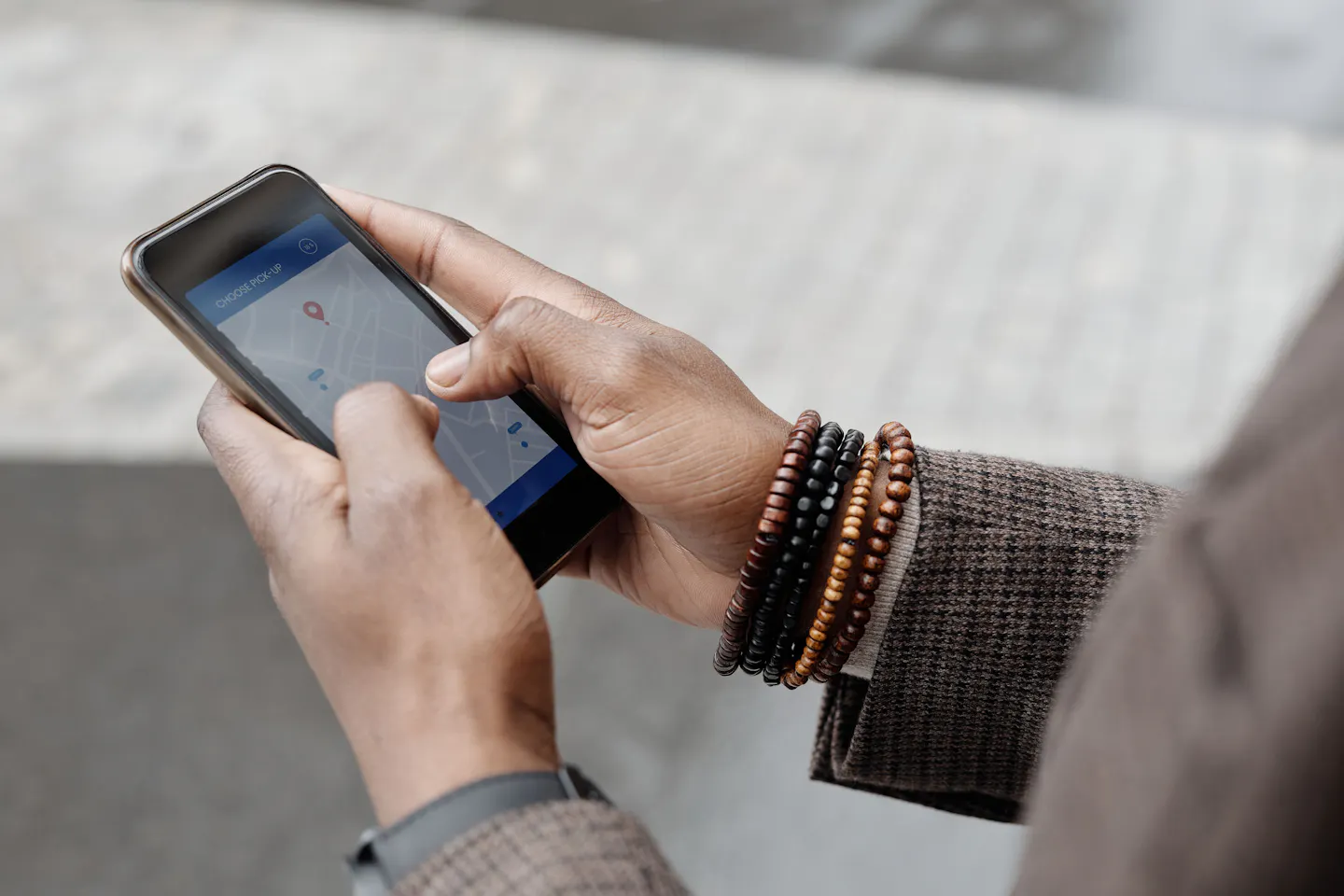 Hands using a smartphone navigation app outdoors