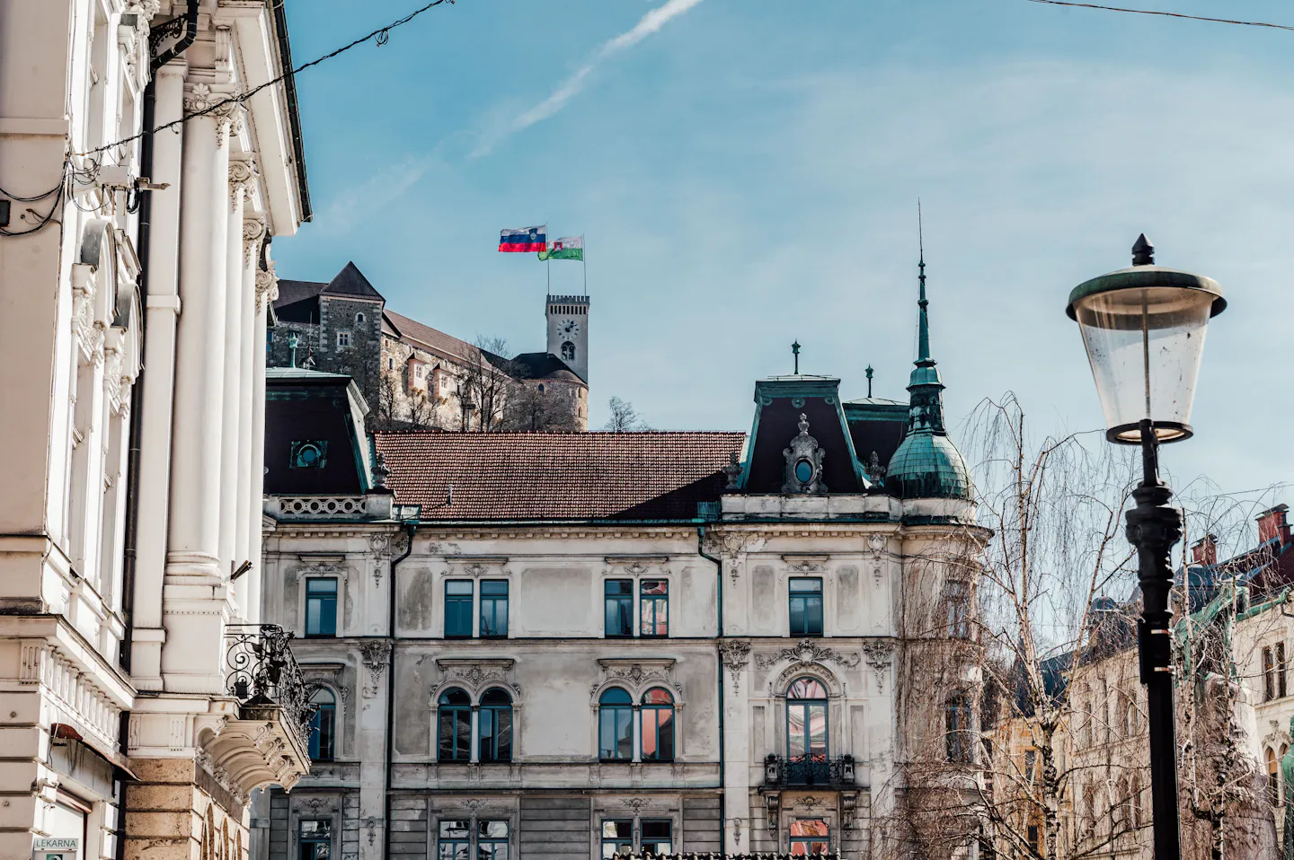 Ljubljana Castle on its wooded hill above the ornate facades of the old town on a clear winter day