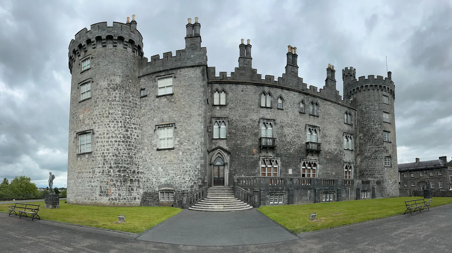 Kilkenny Castle in Ireland under a cloudy sky