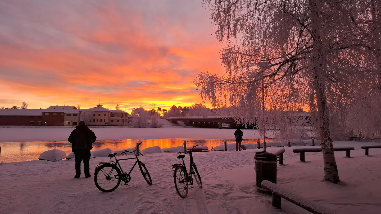Winter sunset over the frozen river and snowy landscape at Oulu, Finland