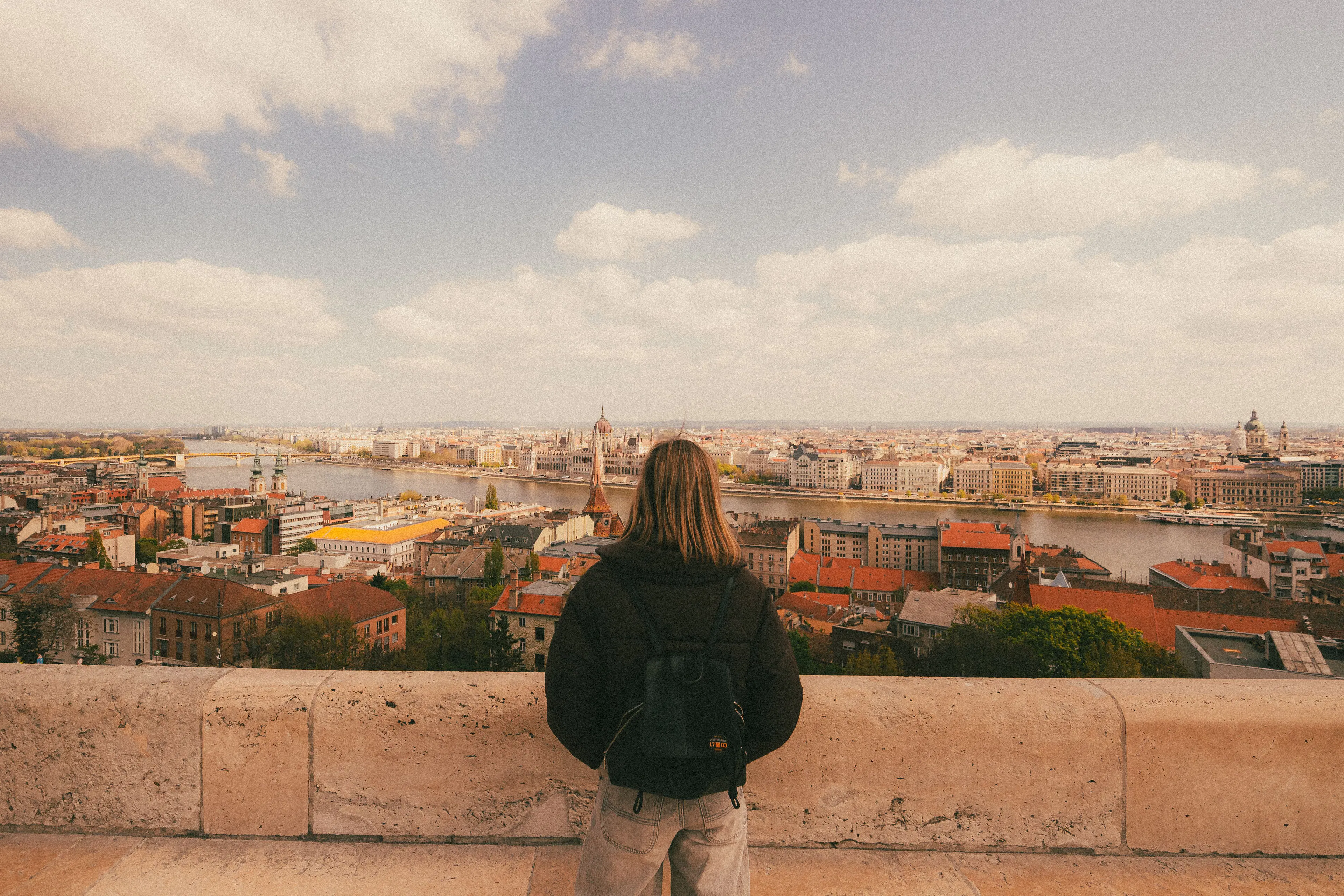 Traveler looking out over Budapest and the Danube from a hilltop viewpoint