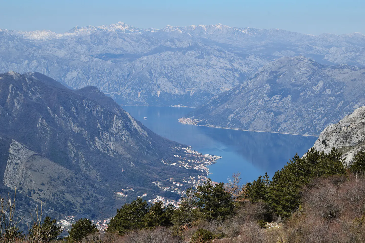The Bay of Kotor winding between steep grey mountains in Montenegro