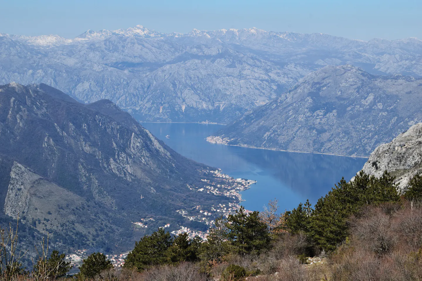 The Bay of Kotor winding between steep grey mountains in Montenegro