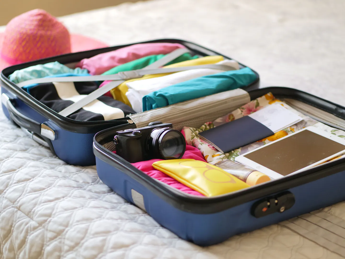 An open suitcase with travel clothes and essentials
