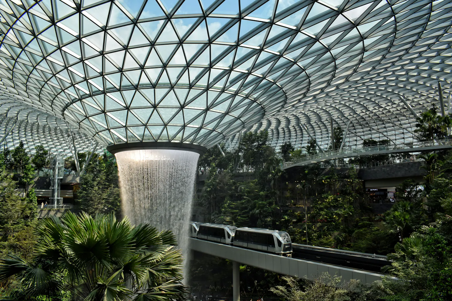 Rain Vortex waterfall, indoor gardens and the airport skytrain at Jewel Changi Airport, Singapore