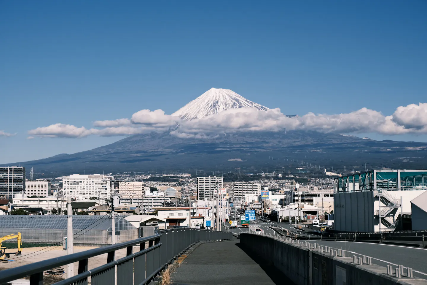 Mount Fuji rising above a Japanese city on a clear day