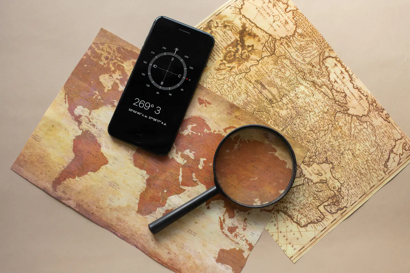 A phone compass and map on a desk