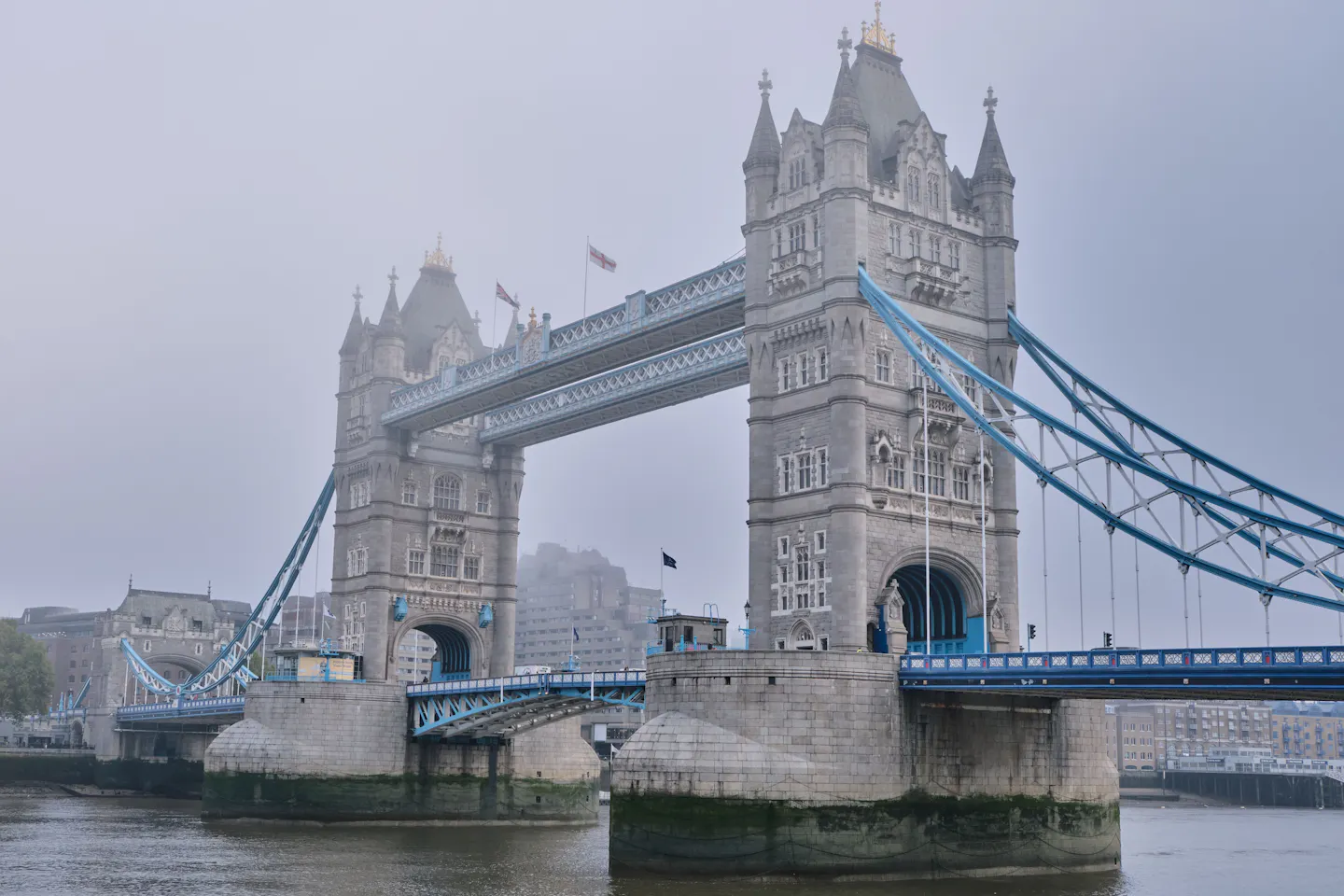 Tower Bridge rising out of low grey mist over the River Thames in London
