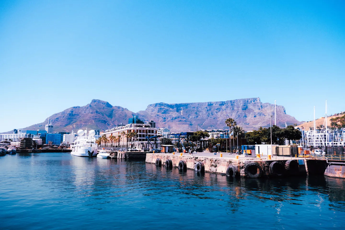 Cape Town’s V&A Waterfront and harbor beneath Table Mountain on a sunny day