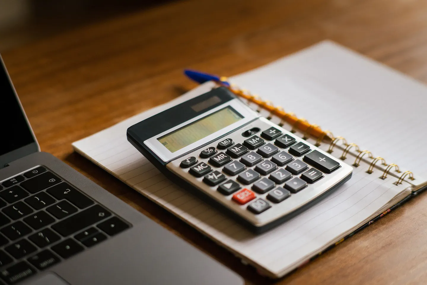 A calculator and notebook for planning a travel budget