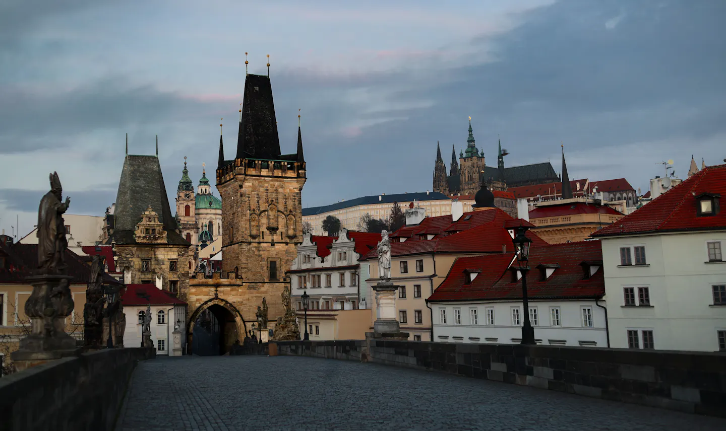 Charles Bridge and the towers of Prague's Old Town under soft low light