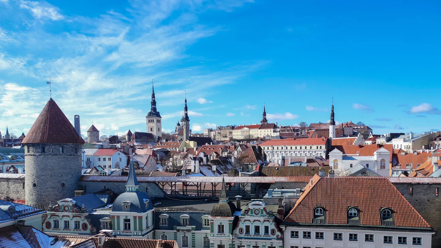 Red roofs, church spires and medieval towers of Tallinn's Old Town under a bright winter sky