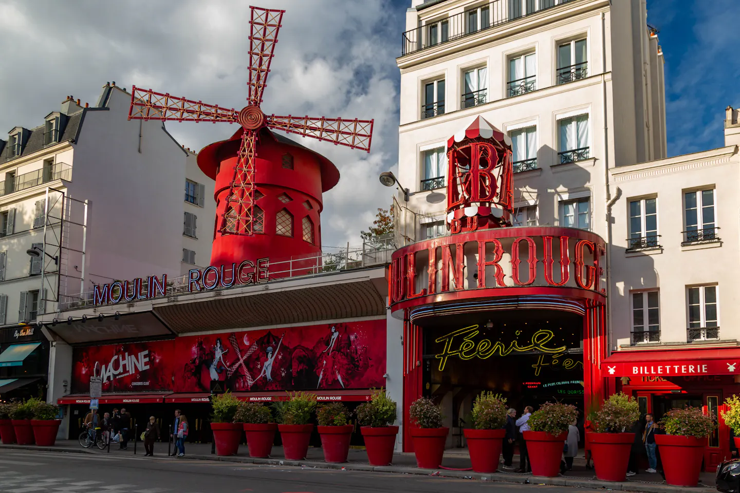 The red windmill and facade of the Moulin Rouge cabaret in Montmartre in warm evening light