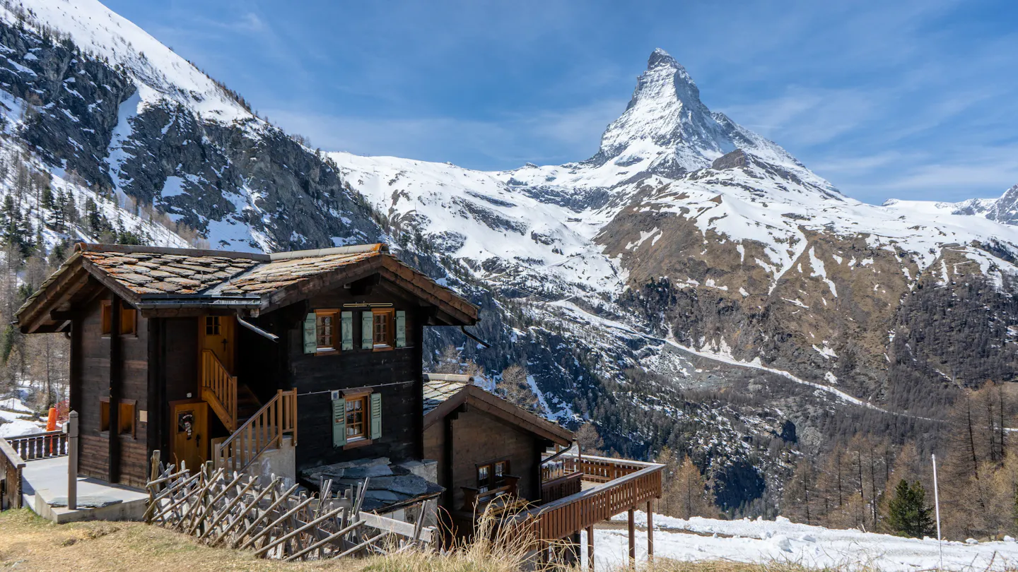 A traditional chalet beneath the snowy Matterhorn in Zermatt, Switzerland