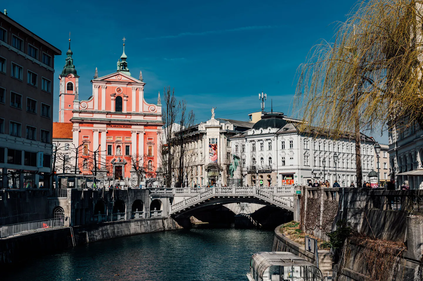 The Triple Bridge and the pink Franciscan Church beside the Ljubljanica river in Ljubljana